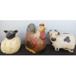 A wooden carved and painted model cow, chicken and sheep.