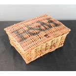 A small Fortnum & Mason wicker basket.