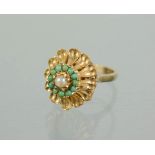 A 9ct gold ring, of flowerhead form, set with a central seed pearl bordered by turquoise roundels.