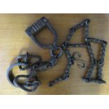 A pair of iron shackles, and an iron chain.