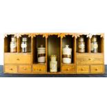 An oak spice rack, composed of various sized drawers and pigeon holes, the upper apron carved with