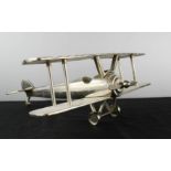 A brushed steel model aeroplane.