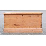 An antique pine blanket chest with iron handles, 43 by 88 by 48cm.