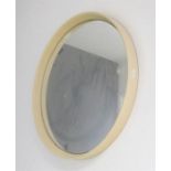 A circular white wall mirror. 54cm diameter.