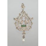 A silver, emerald and ruby necklace pendant, the centre composed of two peacocks set with ruby eyes,