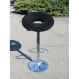 A modern chrome and black velvet bar stool.