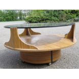 A 1960s coffee table with faux rosewood veneer, and circular smokey glass top, 85cm diameter, 45cm