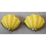 A pair of kitch pale yellow glass and chrome shell form wall lights.