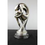A silvered female sculpture of modernist form.