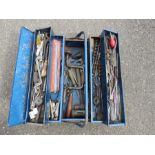 A blue metal tool box with hammers, drill bits, spanners etc.