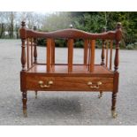 A mahogany canterbury, with turned spindles and single drawer.
