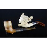 A Meerschaum pipe in the form of a ladies head, and another with silver collar.