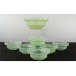 A pale green glass dessert set, one large bowl and six smaller dishes.