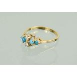 A gold, diamond and turquoise ring, marked 14K, the two diamonds flanked by turquoise to the