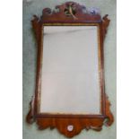 A Georgian mahogany fret carved wall mirror with ho ho bird to the crest. 73 by 41cm