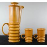 A Carlton ware coffee pot and two cups in ochre.