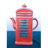 A tea pot in the form of a red phone box.