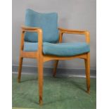 A 1960s teak Danish armchair with flip back, original teal upholstery.