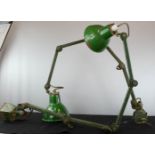 A pair of green angle poise bench lamps.