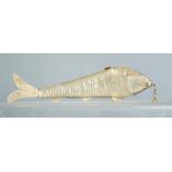 An Indian white metal articulated fish modelled as an Arowana fish, 17cm long.