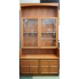 A G-Plan display unit, with two glazed doors, open upper shelf and two cupboard doors below.