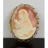 A 9ct gold cameo brooch, with oval scrollwork setting, the cameo carved with child praying, 19.6g