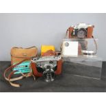 A group of vintage cameras, a Corfiled, Zenith, Ensign, and accessories.