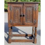 A small oak carved cupboard.