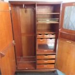 A retro compactum wardrobe, with labelled drawers of various sizes, 189 by 107 by 49cm.