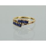 An 18ct gold and sapphire ring, set with six square cut sapphires, 2.6g.