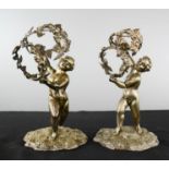 A pair of white metal putti eperge holders.
