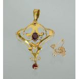 A 9ct gold Art Nouveau style pendant and safety chain, set with red paste stones and drop pendant,