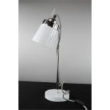 A white and chrome table lamp.