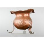 An Arts & Crafts planter in copper, H: IV, raised on three feet.