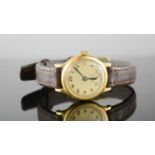 An 18ct gold cased wristwatch, with Arabic dial, and brown leather strap.
