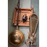 A quantity of brassware including a fan fireguard, bed pan, antique iron etc.