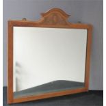 A wall mirror, with carved crested top in the Regency style.