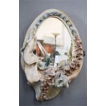 A Robin Wade ceramic wall mirror, Hollyhocks.