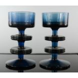 A pair of mid 20th century smokey blue glass candlesticks, 12cm high.