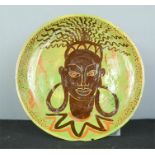 A ceramic studio pottery plate, African lady, green ground.