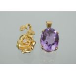 A 9ct gold and amethyst oval pendant and a 9ct gold flowerhead pendant with central diamond, 5.9g