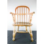 A 19th century elm child's Windsor armchair.