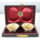 A pair of silver salts, embossed with gilt interior and original spoons and presentation box.