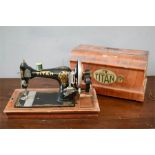 A Titan sewing machine in the original wooden case.