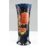 A Moorcroft trumpet vase, circa 1920, Pomegranate pattern, impressed to the base and signed