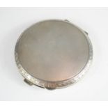 A silver compact bearing the inscription 'Pat, With Love, DK, 17th Nov 62'.