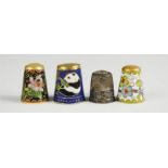 Three champleve enamel thimbles; one depicting a panda, and a silver thimble. (4)
