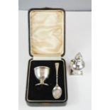 A silver Christening set; bakelite lined egg cup Birmingham, and spoon Sheffield 1919, together with