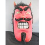 A large red devil mask.