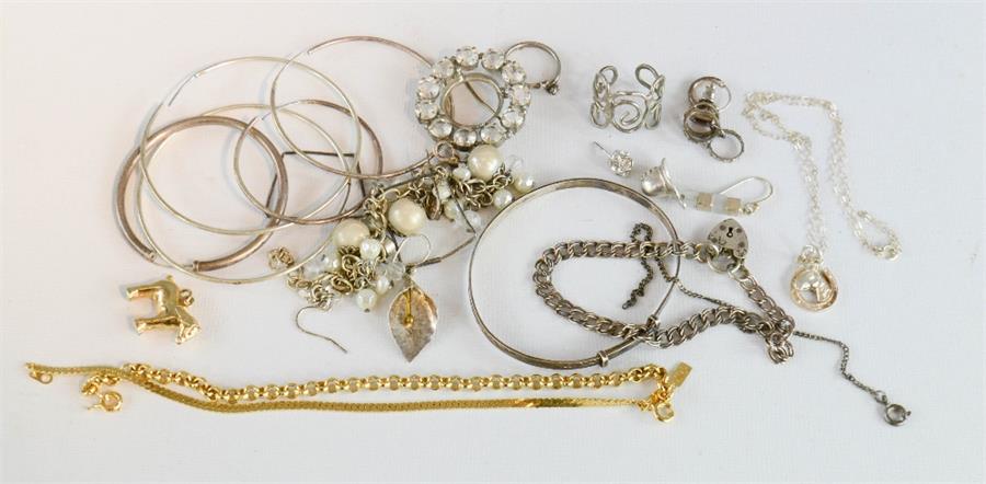 A group of silver bangles, earrings, bracelet with heart form charm, a horse pendant necklace etc.